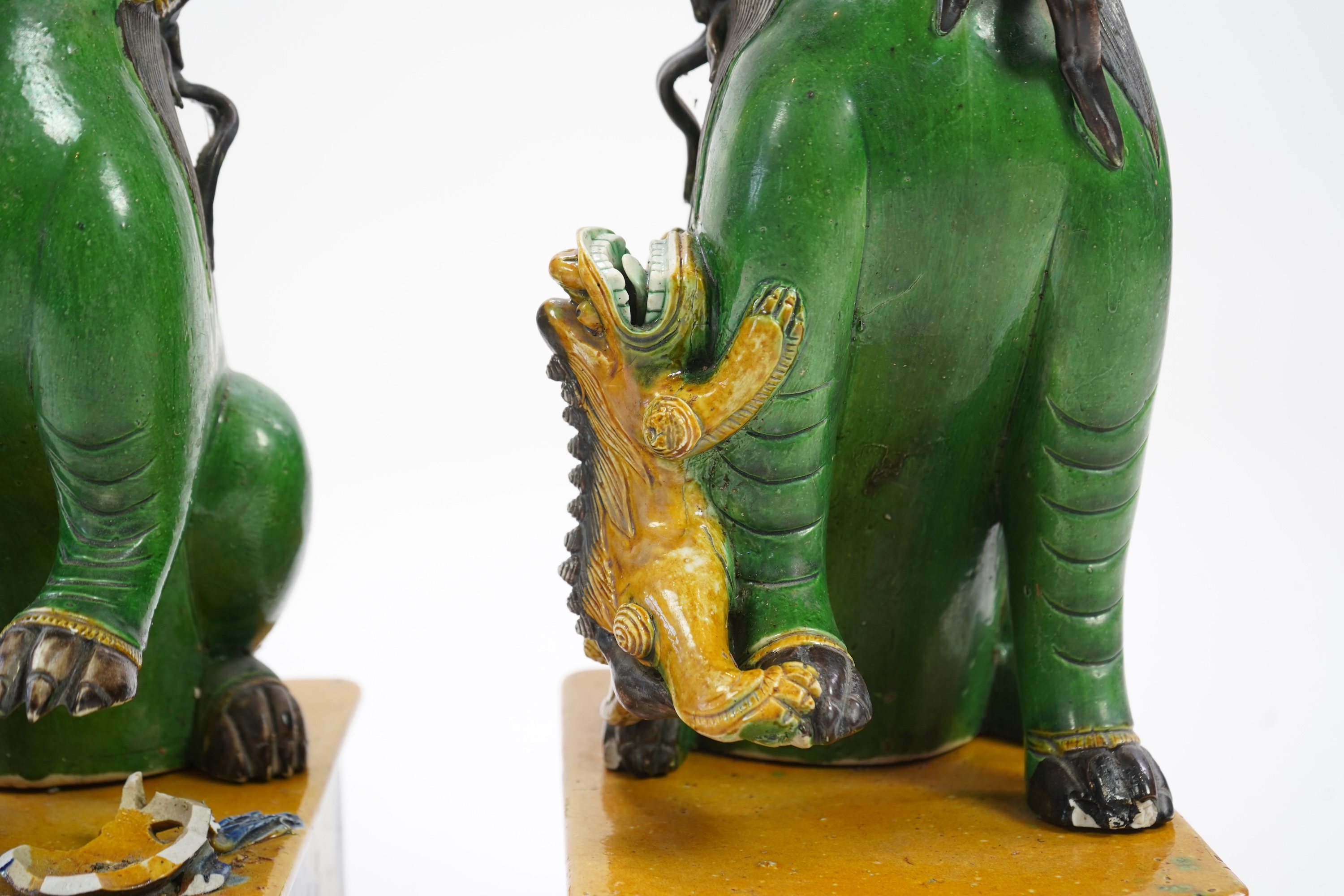 A pair of large Chinese sancai-glazed biscuit figures of Buddhist temple lions, 19th century